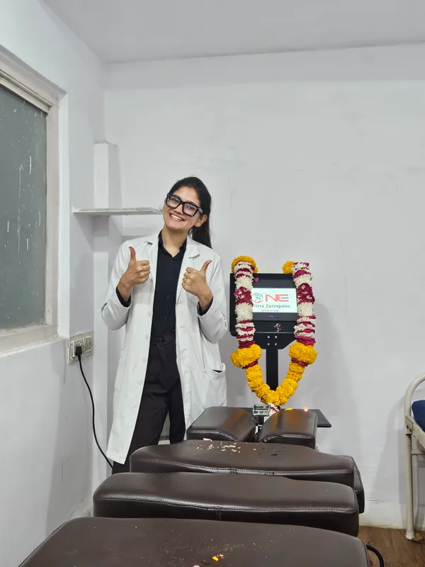 Spine decompression machine and treatment table with a person standing beside the console.