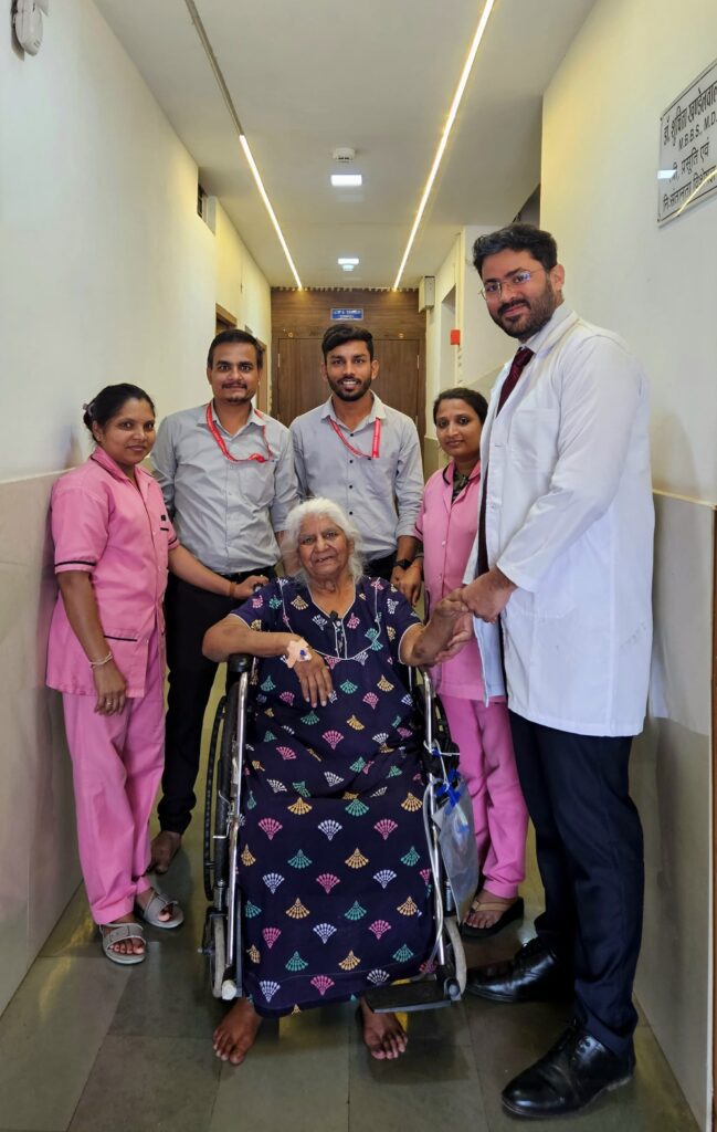 Dr. Anupam Khandelwal with 86 year old happy patient after Hip Replacement with Dr. Anupam Khandelwal Joint Clinics staff